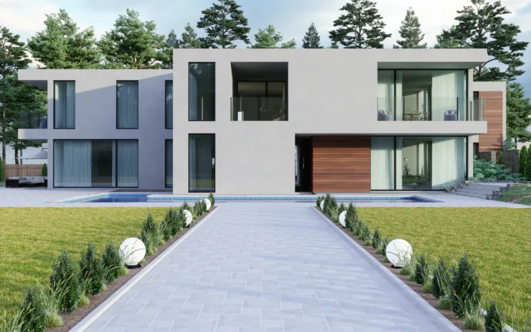Architecture blanche à volumes décalés, accès pavé